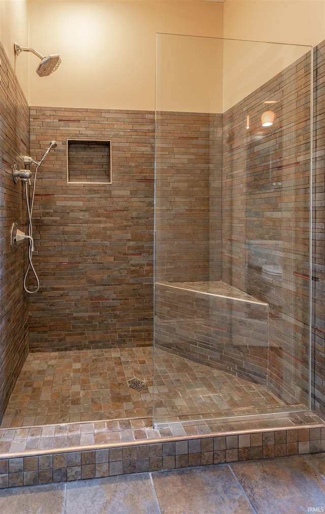 bathroom with tiled shower