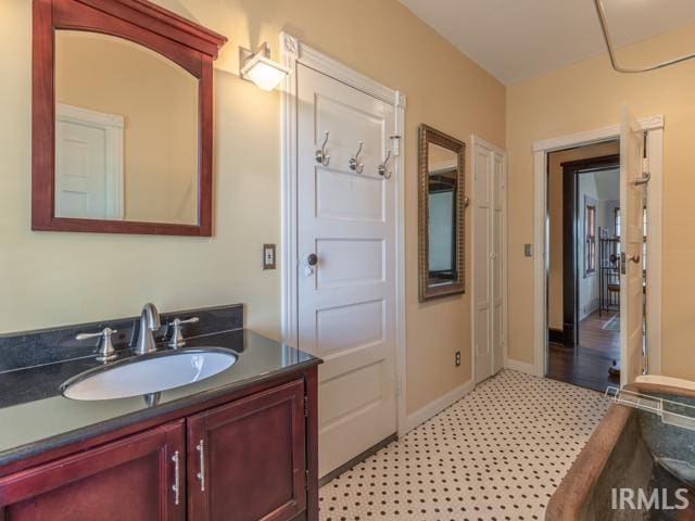 bathroom featuring vanity and tile floors