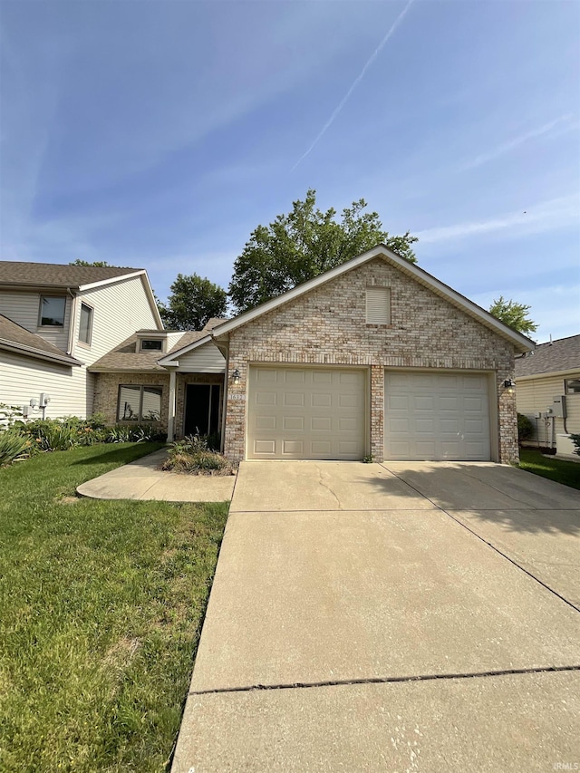 view of front of property with a garage and a front yard