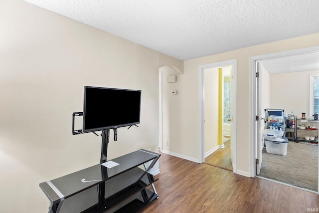 interior space featuring a textured ceiling and hardwood / wood-style flooring