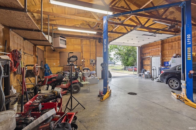 garage featuring wood walls