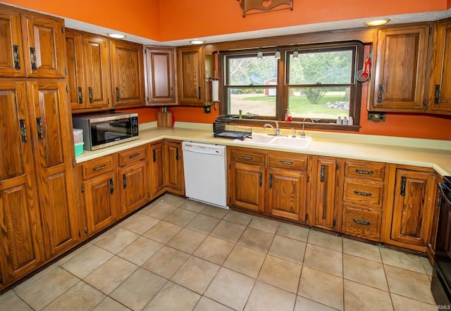 kitchen with dishwasher, light tile patterned flooring, and sink