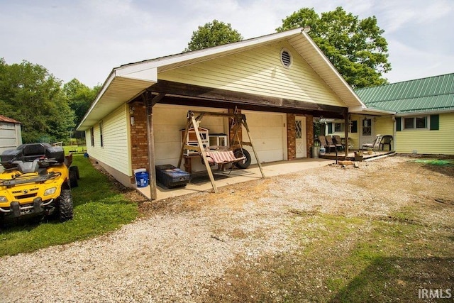 rear view of house with a garage