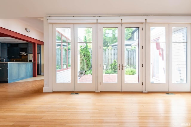 doorway featuring light hardwood / wood-style flooring and french doors