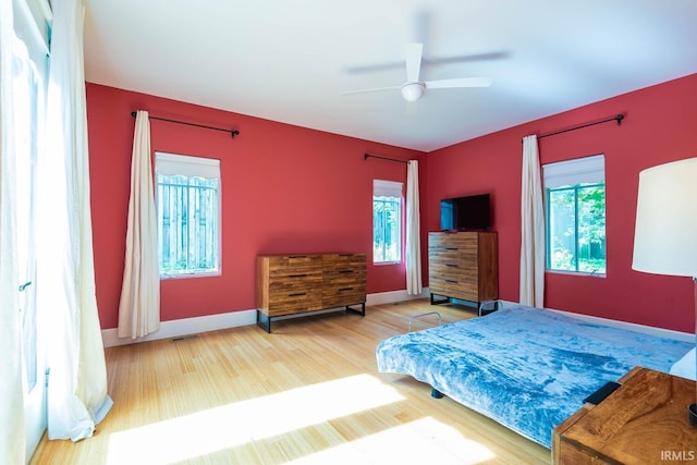 bedroom with ceiling fan and hardwood / wood-style floors