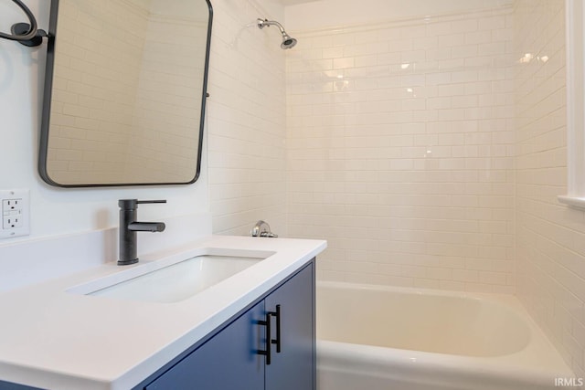 bathroom featuring vanity and tiled shower / bath combo