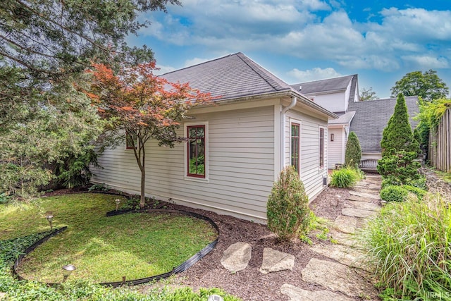 view of property exterior with a yard