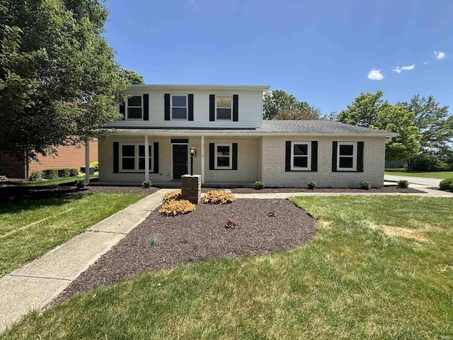 front facade with a front lawn and a porch