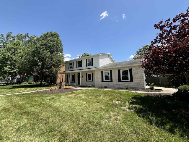 view of front of property with a front yard and central air condition unit