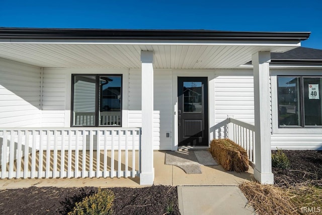 entrance to property featuring covered porch