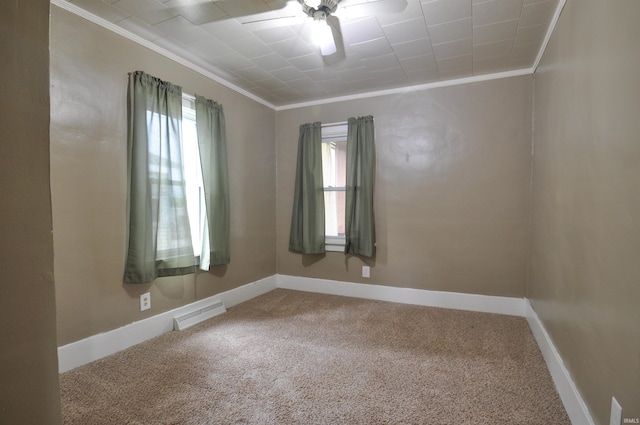 carpeted spare room featuring a healthy amount of sunlight, ornamental molding, and ceiling fan