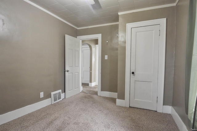 unfurnished bedroom featuring carpet and ornamental molding