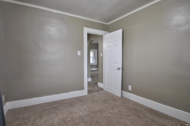 empty room with carpet floors and crown molding