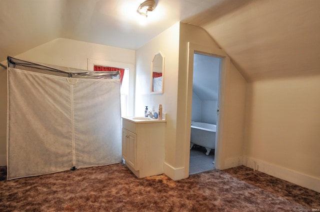 bonus room featuring vaulted ceiling and carpet