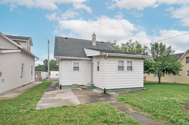 back of house with a patio and a yard