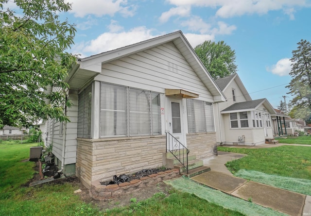 bungalow-style home with a front yard