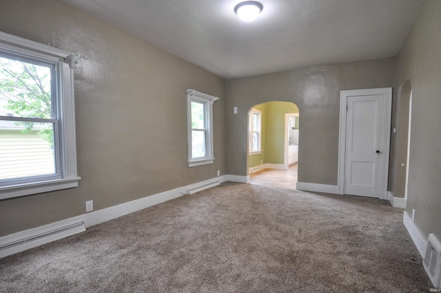 empty room with carpet floors and baseboard heating