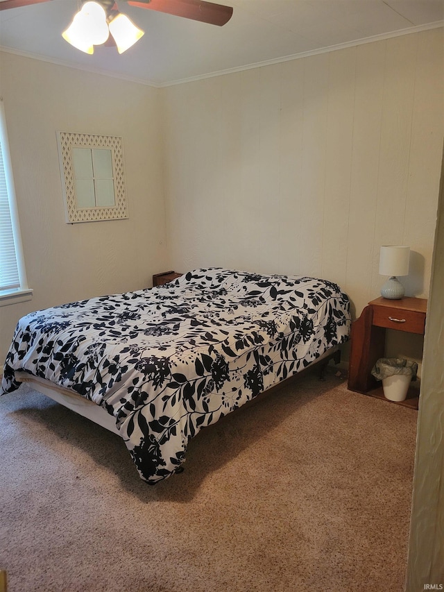 bedroom featuring ceiling fan, carpet floors, and ornamental molding