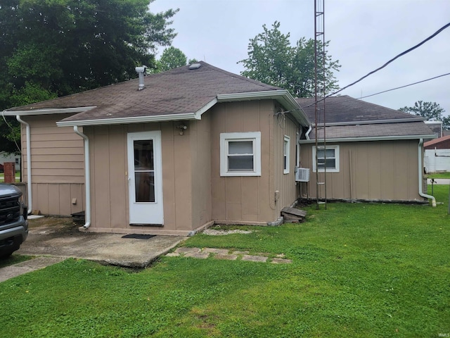 back of property with a yard and cooling unit