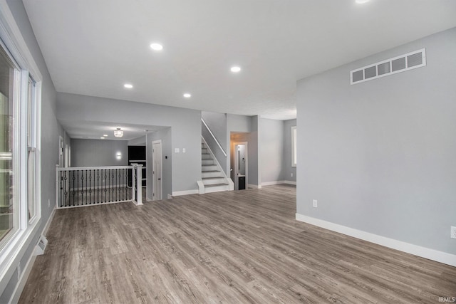 unfurnished living room with wood-type flooring