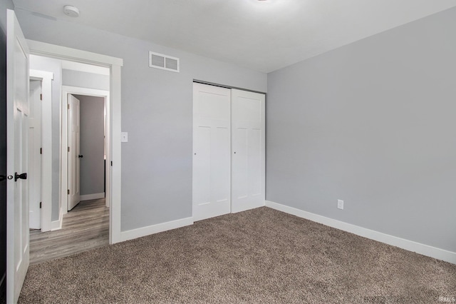 unfurnished bedroom featuring a closet and carpet