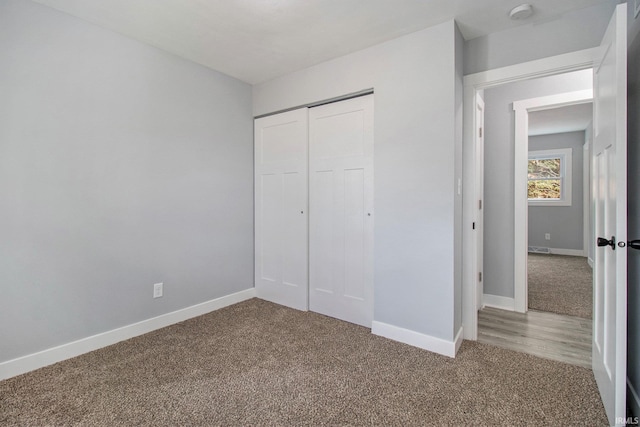 unfurnished bedroom with carpet and a closet