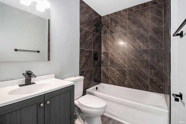 full bathroom featuring vanity, hardwood / wood-style flooring, toilet, and tiled shower / bath