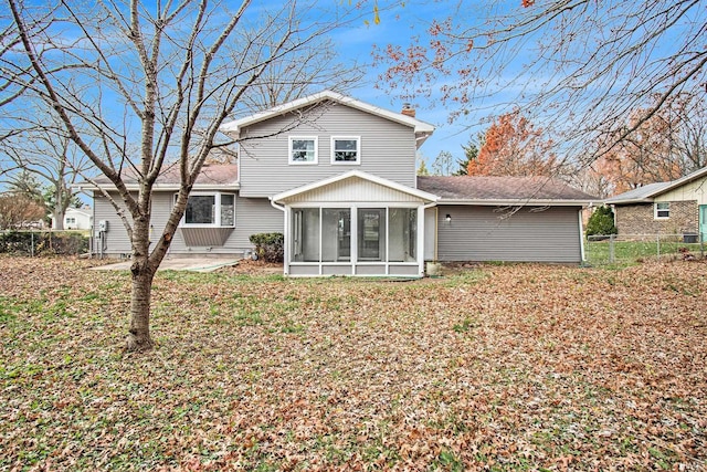 back of house featuring a patio and a sunroom