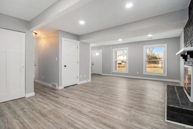 unfurnished living room featuring light hardwood / wood-style floors