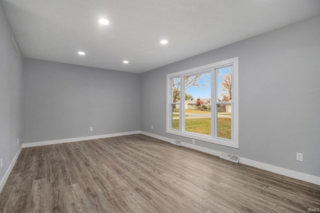 unfurnished room with wood-type flooring