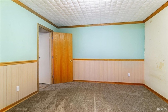 carpeted spare room with crown molding