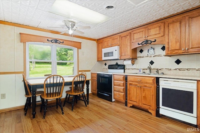 kitchen with white appliances, light hardwood / wood-style floors, ceiling fan, and ornamental molding