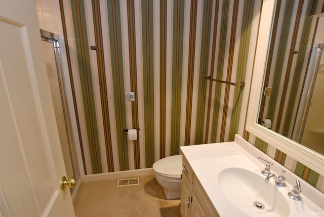 bathroom featuring toilet and vanity