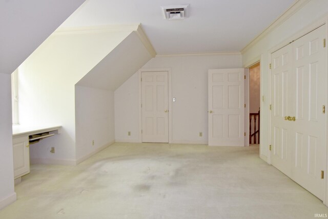 bonus room with light carpet and vaulted ceiling