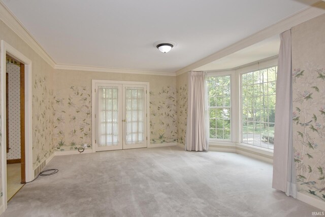 carpeted empty room with ornamental molding and french doors