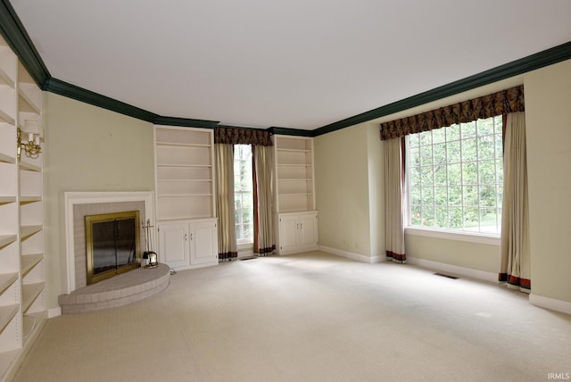 unfurnished living room with a brick fireplace, ornamental molding, light carpet, and built in features