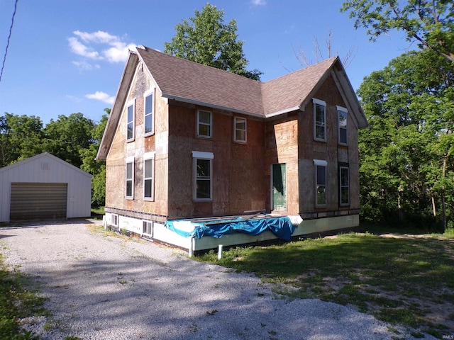 view of front of property featuring an outdoor structure and a garage