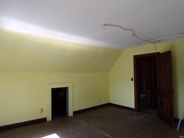 additional living space featuring lofted ceiling