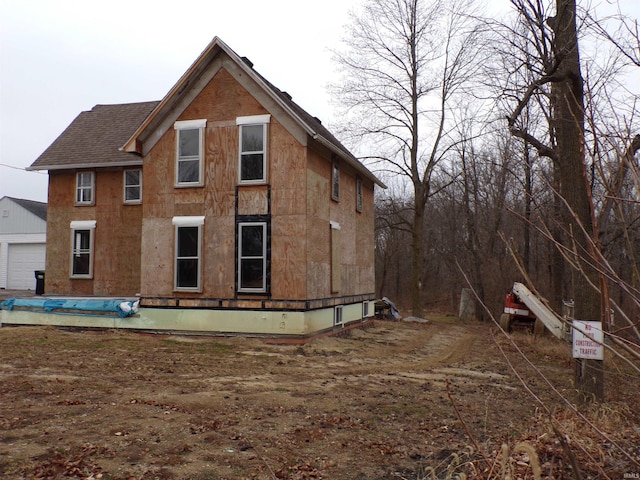 rear view of property with a garage