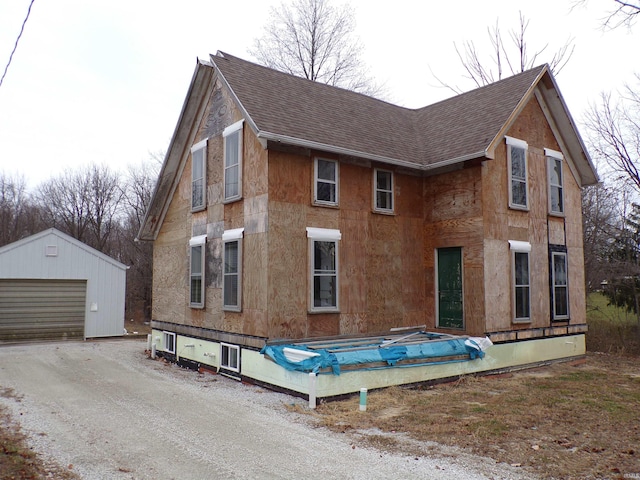 view of side of property featuring a garage and an outdoor structure