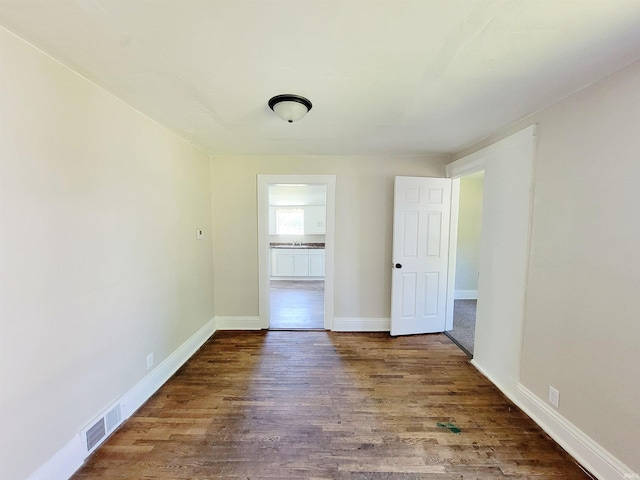 spare room featuring wood-type flooring