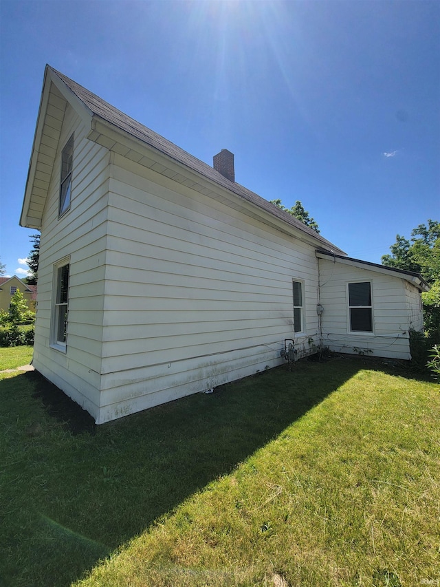 view of property exterior with a lawn