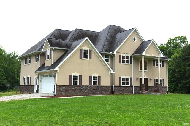 view of front of home featuring a front yard and a garage