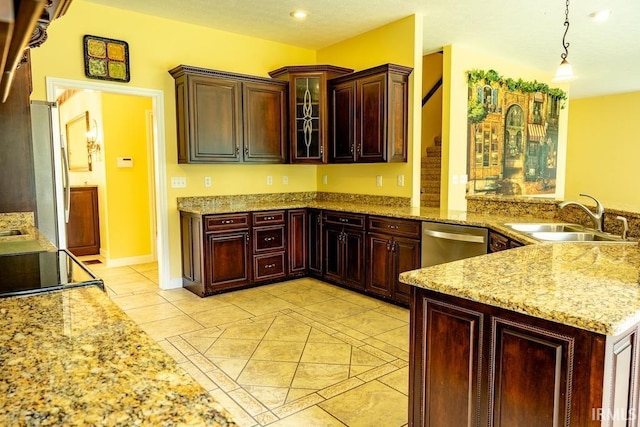 kitchen featuring dishwasher, sink, hanging light fixtures, light stone countertops, and light tile patterned flooring