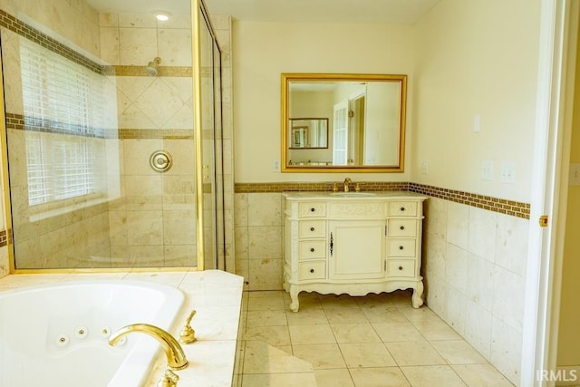 bathroom with tile patterned flooring, vanity, tile walls, and a washtub