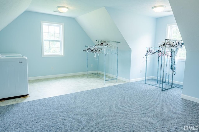 additional living space featuring carpet, lofted ceiling, and washer / clothes dryer