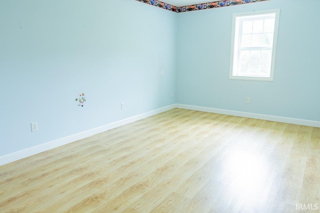 spare room with light hardwood / wood-style flooring