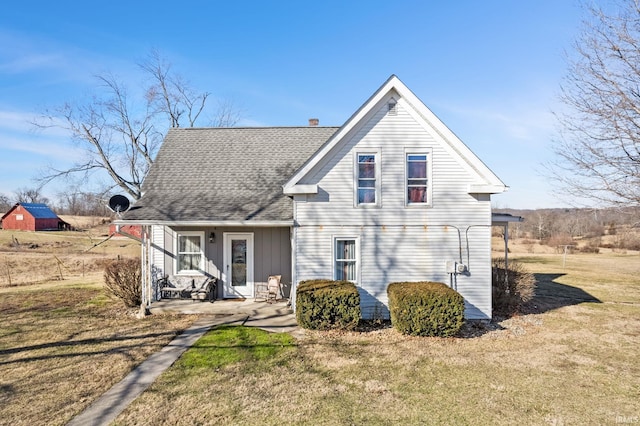 rear view of house with a yard