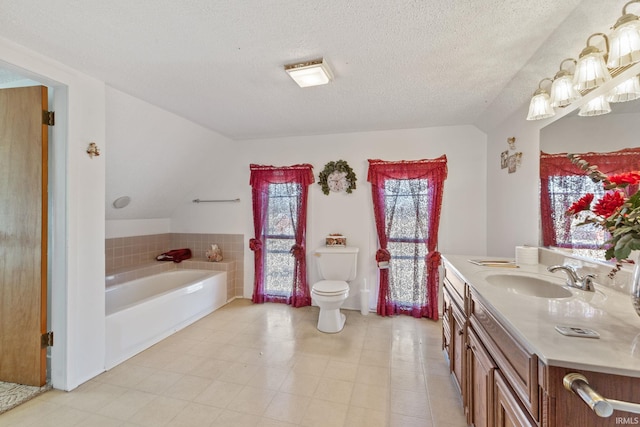 bathroom with a bathtub, toilet, a textured ceiling, and vanity