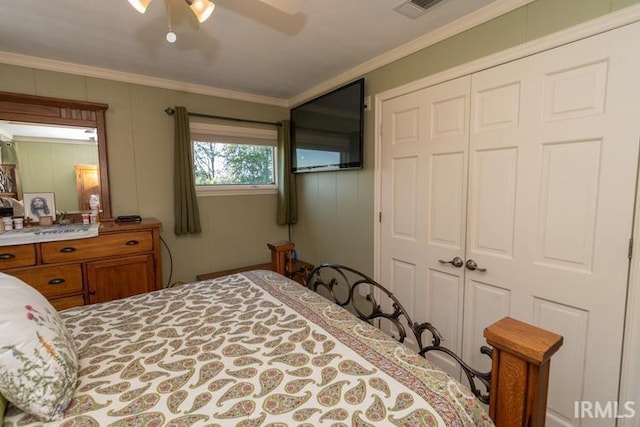 bedroom with a closet, ceiling fan, and crown molding